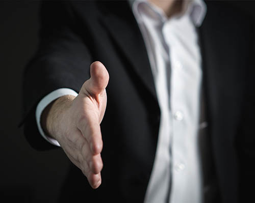 Top Performing Salespeople - shaking hands and displaying confidence