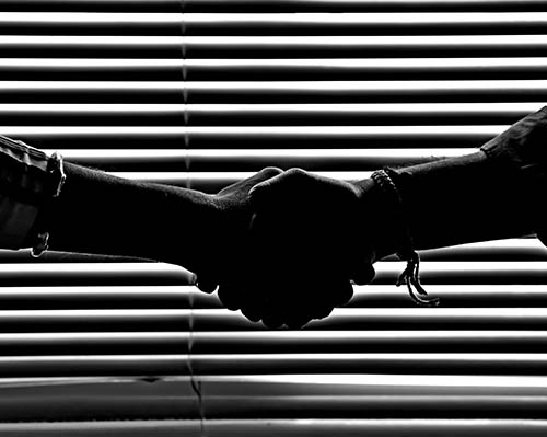 Strategic alliances - Firm handshake symbolising the alliance of two parties